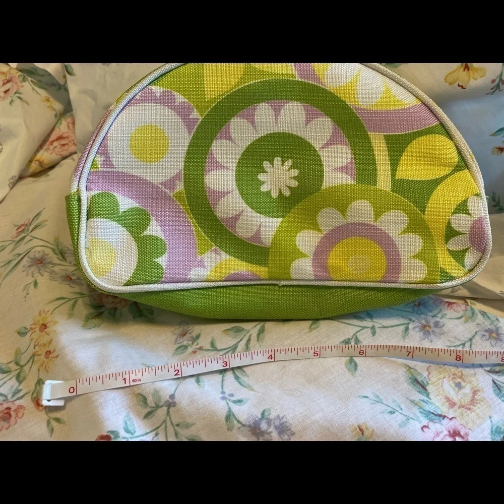 Clinique NWOT cosmetic bag. Green, yellow, purple and white. White inside